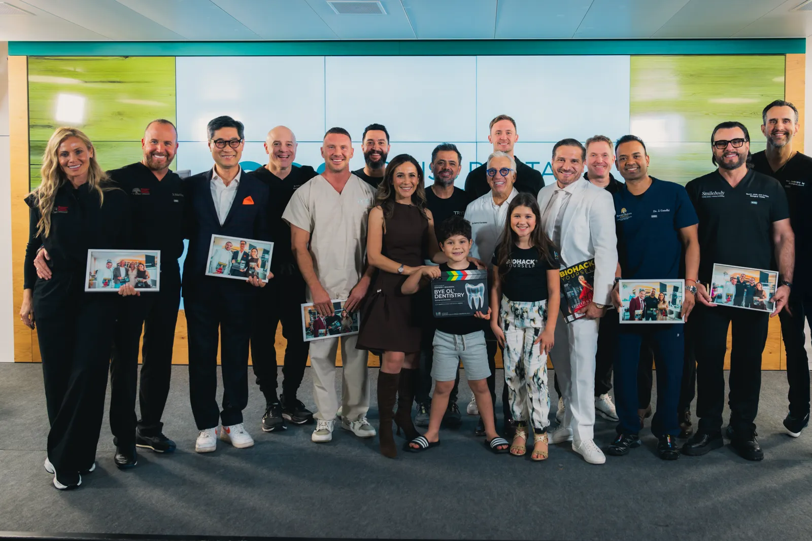 A group of biological dentists holding copies of the magazine