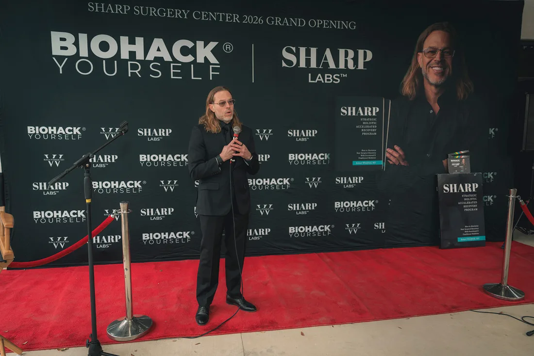 A client grand opening on the red carpet in front of a co-branded wall