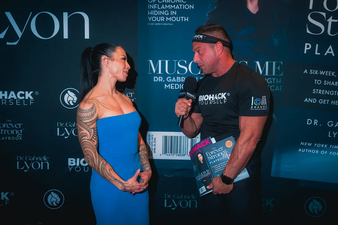 Dr. Gabrielle Lyon with a reader holding the magazine at her book event